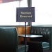 A Chef Master hostess sign on a table in a restaurant.