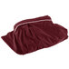 A maroon Snap Drape table skirt in packaging with a white background.