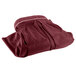 A burgundy Snap Drape table skirt folded on a white background.