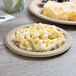 A plate of macaroni and cheese on an Eco-Products wheat straw plate.