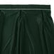 A jade green table skirt with a white band and silver clips.