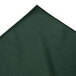 A close-up of a green fabric with a white edge.
