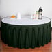 A table with a green Snap Drape Wyndham table skirt with Velcro clips.