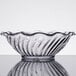 A clear glass GET dessert dish on a table.