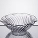 A clear glass GET dessert dish with a wavy edge.