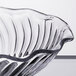 A close up of a clear GET dessert dish with a wavy edge.