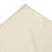 A beige Snap Drape table skirt with a corner.