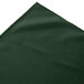 A close-up of a dark green Snap Drape box pleat table skirt.