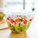 A salad in a clear plastic Eco-Products salad bowl with a lid.