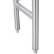 A close-up of a metal leg on an Advance Tabco equipment filler table.