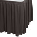 A Snap Drape charcoal box pleat table skirt on a table.