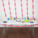 Burgundy Creative Converting streamers on a table with a white cake and cups.