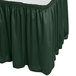 A Snap Drape Wyndham jade green shirred pleat table skirt on a table.