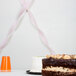 A table with a Classic Pink Streamer Paper ribbon on it.