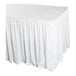 A white shirred pleat table skirt with Velcro clips designed to fit around a table.