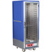 A blue Metro C5 heated holding cabinet with clear door and wheels.