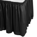 A black Snap Drape Wyndham shirred pleat table skirt on a white table.