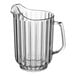 A clear plastic pitcher with a handle.