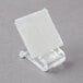 A clear plastic holder with a white square velcro clip.