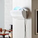 A white Lavex Zap N Trap wall sconce with a blue light.