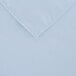 A light blue square cloth table cover with a white hem.