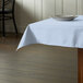 A table with a light blue Intedge cloth table cover and a plate.