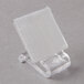 A clear plastic holder with a white surface on a table stand.