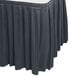 A Snap Drape slate blue box pleat table skirt on a table.