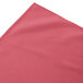 A dusty rose shirred pleat table skirt on a table with Velcro clips.