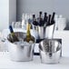 A silver American Metalcraft beverage tub with wine bottles in ice.