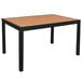 A BFM Seating black aluminum bar height table with a synthetic teak top.