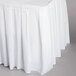 A white box pleat table skirt on a table.