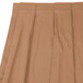 A Snap Drape sandalwood box pleat table skirt with velcro clips on a table.