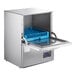 A Noble Warewashing undercounter dishwasher with a blue tray inside.