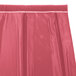 A dusty rose Snap Drape box pleat table skirt with velcro clips on a table.