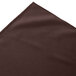 a brown cloth with a white edge