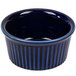 A blue fluted china ramekin with a striped rim.
