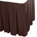 A brown table skirt with pleated edges.