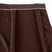 A brown Snap Drape table skirt with pleats.