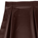 A brown Snap Drape Wyndham table skirt with continuous pleats.