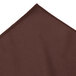 A brown table skirt with a pleated edge.