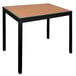 A BFM Seating Longport standard height table with a synthetic teak top and black aluminum base.