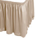 A beige table skirt with a shirred pleat edge.