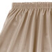 A beige Snap Drape table skirt with ruffles.