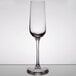 A clear Stolzle Revolution wine flute on a table.