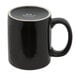 A black Tuxton china mug with a white rim and C-handle.