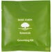 A green Basic Earth Botanicals grooming kit package with white text and a white tree.