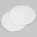 A close-up of two round white Basic Earth Botanicals pads.