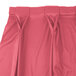 A Snap Drape dusty rose table skirt with bow tie pleats.