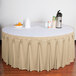 a table with a white tablecloth and a bowl of oranges